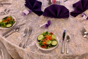 Beautiful Purple Centerpieces and full White linens, and preset salads at the Red Oak Ballroom B in San Antonio