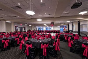 Red Oak Ballroom Houston/CiryCentre set for a large Holiday Party, chair covers with ties, standard centerpiece and dance floor