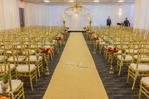Elegant Wedding Ceremony Room Setup with perimeter pipe and drape and bamboo guest chairs at the Red Oak Ballroom in Houston, CityCentre