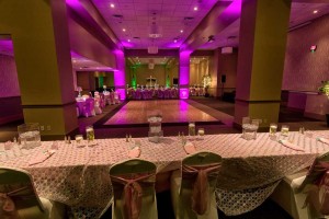 Dramatic Hot Pink and Green lighting with Pink and Ivory Linens for a Wedding at the Red Oak Ballroom B in Fort Worth, Sundance Square