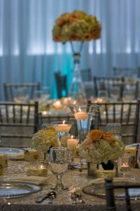Gorgeous White Linens, Silver Bamboo Chairs, perimeter pipe and drape with Aqua Uplighting room setup at the Red Oak Ballroom in Houston, CityCentre