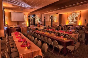 Massive, custom Company Holiday Party set with Specialty lighting and table decorations at Red Oak Ballroom Austin