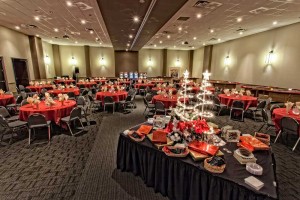 Festive black and red Holiday Party set with Specialty Dessert Display table at Red Oak Ballroom Austin