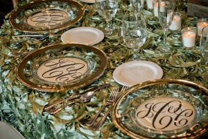 Ornate green Table Overlays with silver rimmed plate chargers at Red Oak Ballroom, Houston CityCentre