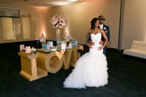 Happy Couple posing in front of a Candy Display at the Red Oak Ballroom in Houston, CityCentre